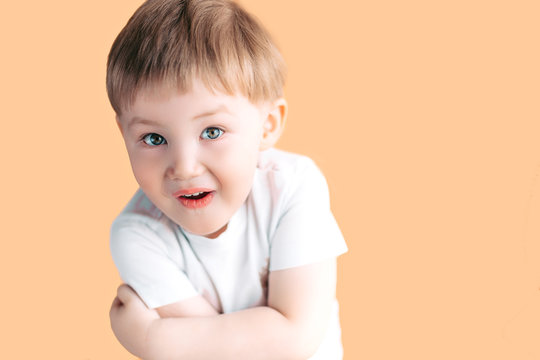 Portrait of little boy screaming with opened mouth and crazy expression. Surprised or shocked face