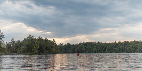 a woman enjoys kayaking in the wilderness