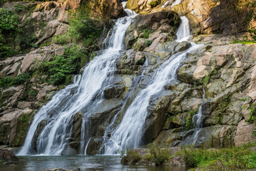Naklejka na ściany i meble Beautiful waterfall in green forest