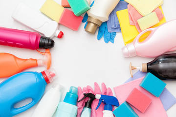 Cleaning equipment on light background. Bottles with detergent and cleaning tools. Colorful cleaning products. Washing, cleaning concept. 