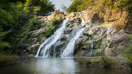 Fototapeta na wymiar Beautiful waterfall in green forest