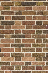 Flemish bond pattern vintage brick wall background with earth tone hued brown brickwork
