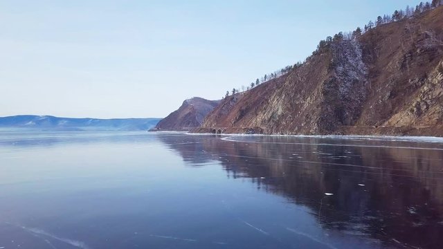 Mountains from aerial view.. Cracks in ice from aerial view. Winter in Siberia, Baikal Lake.