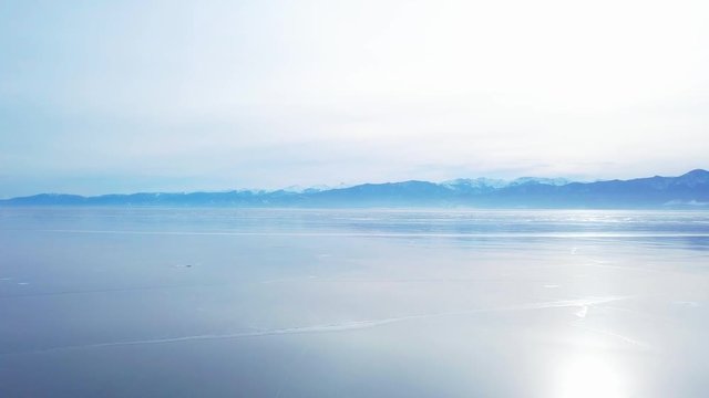 Mountains from aerial view.. Cracks in ice from aerial view. Winter in Siberia, Baikal Lake.