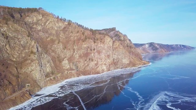 Mountains from aerial view.. Cracks in ice from aerial view. Winter in Siberia, Baikal Lake.