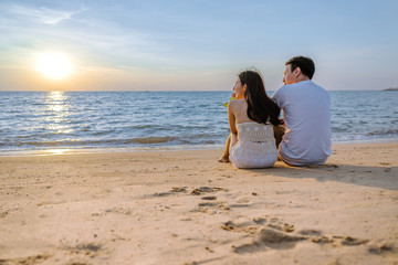 Asian couple are happy with love on the beach at summer weekend holiday.