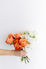 Fototapeta na wymiar A bright modern bouquet on a white background. Wedding decor and minimalism.
