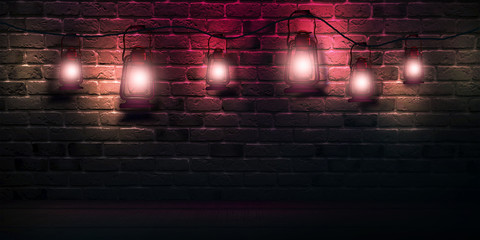 Dark old brick wall with night lanterns, wooden floor. Light spotlights, glare on the wall. Dark...