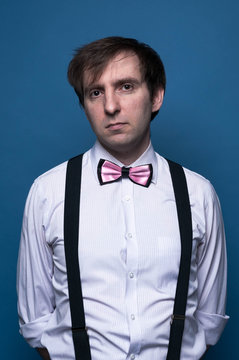 serious handsome man in shirt, pink bow 