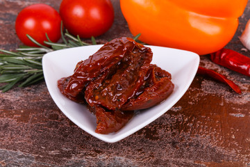 Dried tomatoes in the bowl with olive oil