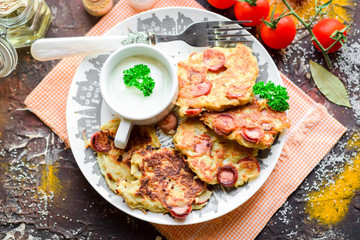 Pancakes with hunting sausages and greens.