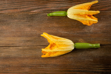 Fresh baby zucchini on wood, food above