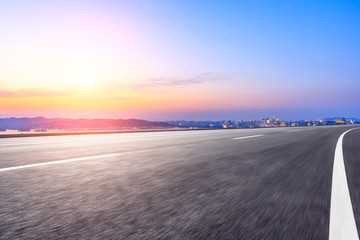 Motion blur asphalt road passing through the city above in Hangzhou at sunset