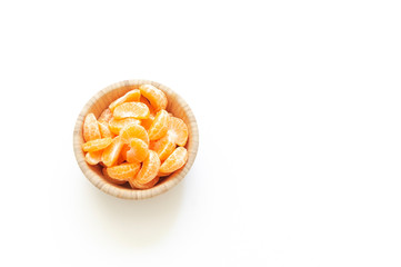 wooden plate with citrus slices on white background