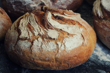 Freshly baked homemade bread loaf on rustic dark background