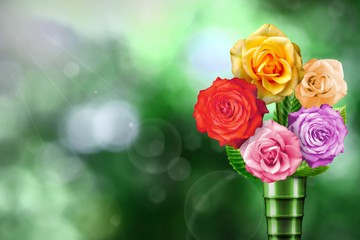 Beautiful live rose bouquet bouquet in modern metal vase with blank place for your text on left on natural leaves and sky blurred bokeh background.