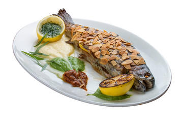 Trout with crispy almond crust and baked mashed potatoes on white background