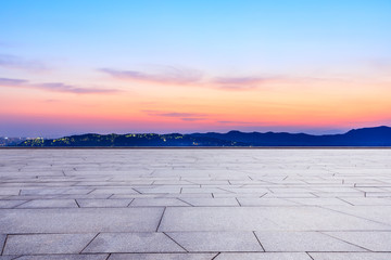 Empty square floor and beautiful mountain nature landscape at sunset