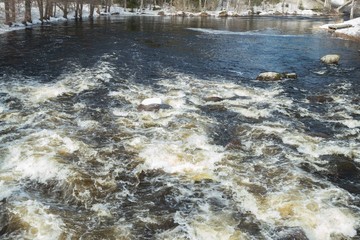 Rough river Jokelanjoki and stones in water, Kouvola, Finland.