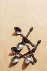 Engraved retro tea spoons on a wooden background. Restaurant concept.