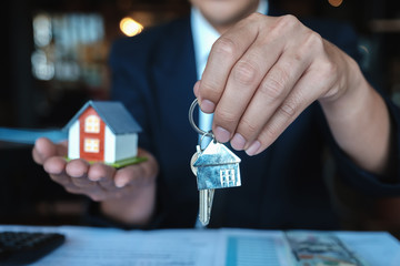 Home loan transaction, Bank officer give key house to customer after making a home purchase contract. loan agreement concept.