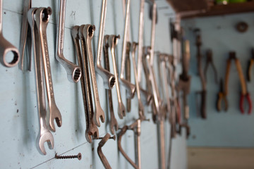 keys in the garage tools. Old tools hanging on wall in workshop , Tool shelf against a wall  in the garage