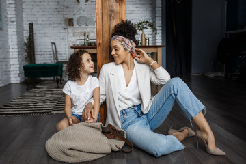 Obraz premium Happy loving family. Young mother and her daughter girl play in kids room. Funny mom and lovely child