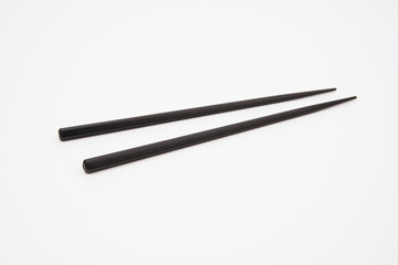 Black wooden chopsticks isolated on white background