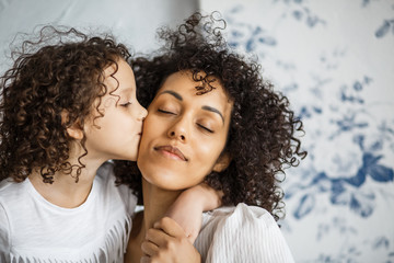 Obraz premium Happy Women's Day. Mom and daughter. Mom and girl are smiling with braces of African-American appearance.