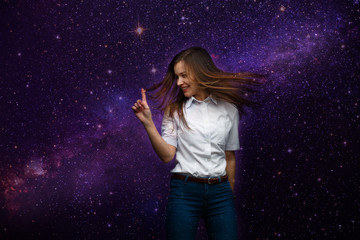 Expressive portrait of a young girl with flowing hair against the background of space.