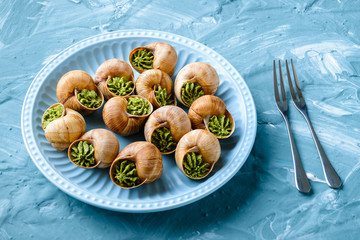 portion of Escargots de Bourgogne or Snails with herbs, view from above