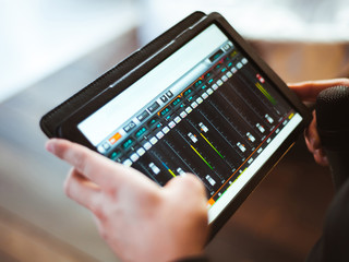 Mixing music on tablet with electronic music instruments concept