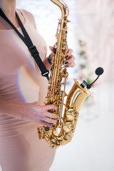 Obraz premium Beautiful girl playing saxophone