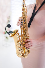 Fototapeta premium Beautiful girl playing saxophone