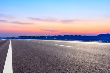 Asphalt road and beautiful mountain nature landscape at sunset