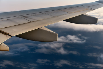 Obraz premium Sky view on clouds from the airplane window at sunset