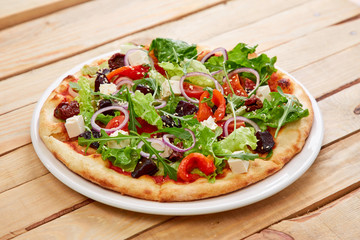 vegetarian pizza with fresh tomatoes, olives, tofu and red onion