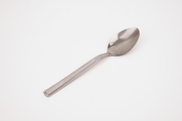 Steel silver spoon isolated on white background 