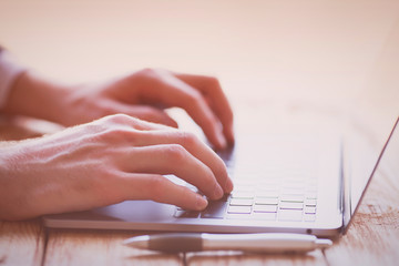 Businessman working with modern devices. Close up male hands, smart phone and laptop. Business, technology, office concept. 