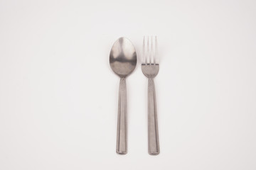Steel silver fork and spoon isolated on white background