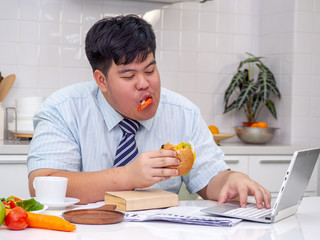 Diet failure of fat man eating fast food unhealthy hamberger.