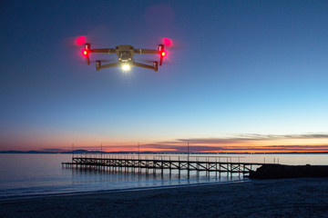 Drone flying and taking pictures of sunset on the sea beach