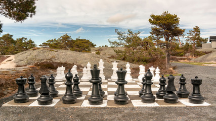 Large chess figures outside, surrounded by trees
