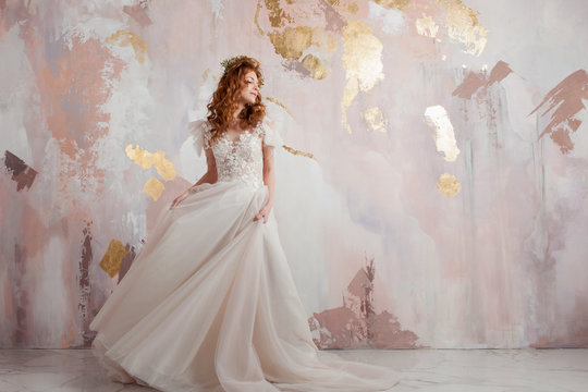 Elegant red-haired girl bride. Young beautiful woman in wedding dress