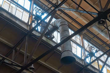 ceiling of old abandoned factories with windows and hoods