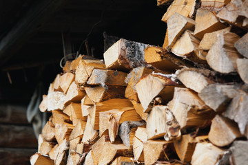 Dry chopped firewood of solid pine and birch wood in a pile.