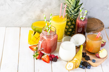 Selection of colourful smoothies in glasses with ingredients, copy space