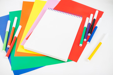 Fototapeta na wymiar Bright stationery for study: paper, felt-tip pens, scissors