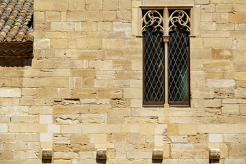 Background with antique window over strong stone wall