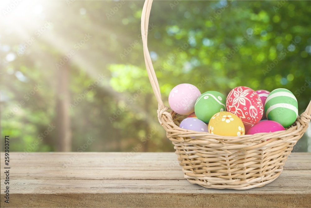 Canvas Prints Easter basket filled with colorful eggs on a white background